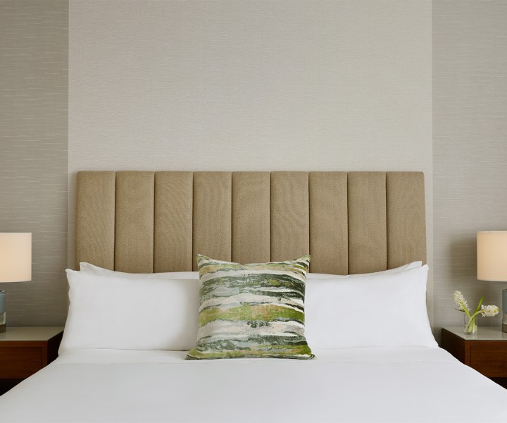 a bed with a pillow and a plant on it