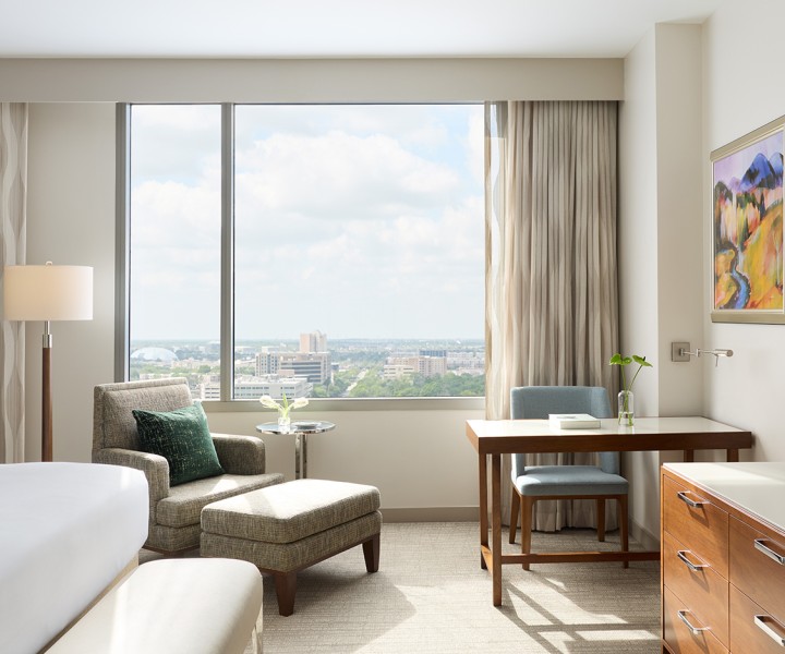 a room with a bed and a table and chairs