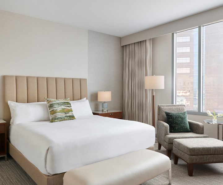 a bedroom with a bed and a chair
