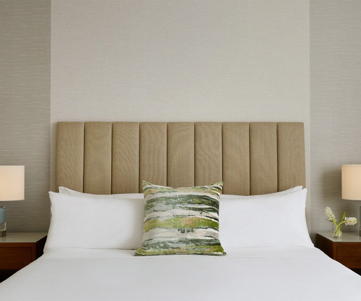a bed with a headboard and a pillow