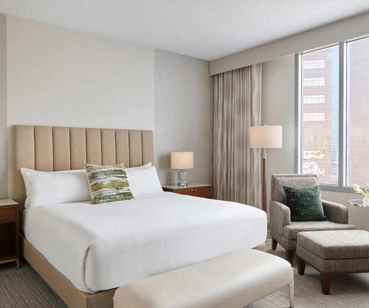 a bedroom with a bed and a chair