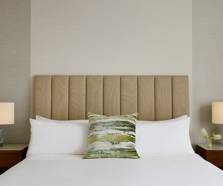 a bed with a headboard and a plant on it