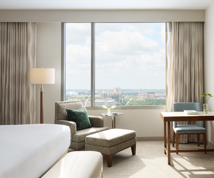 a room with a bed and chairs and a table