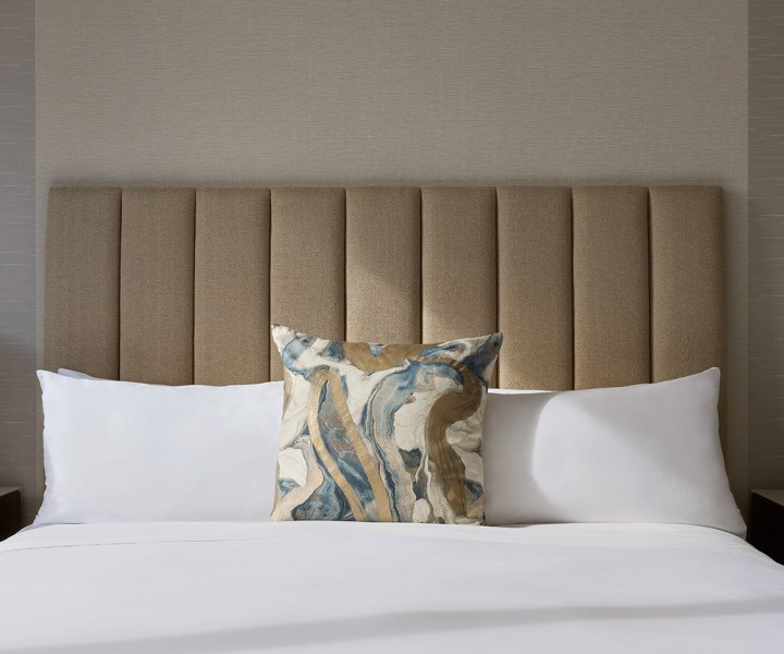 a bed with pillows and a headboard