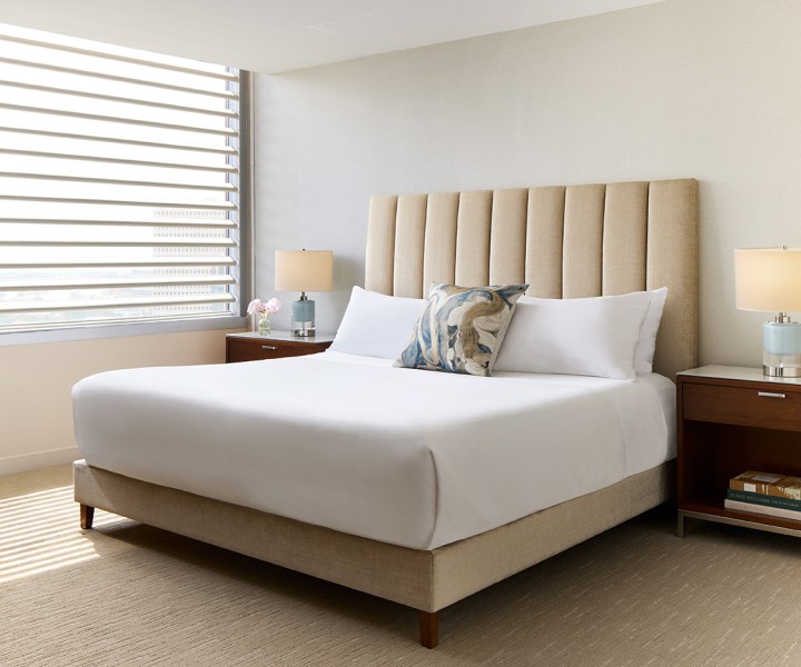a bed with a headboard and a lamp
