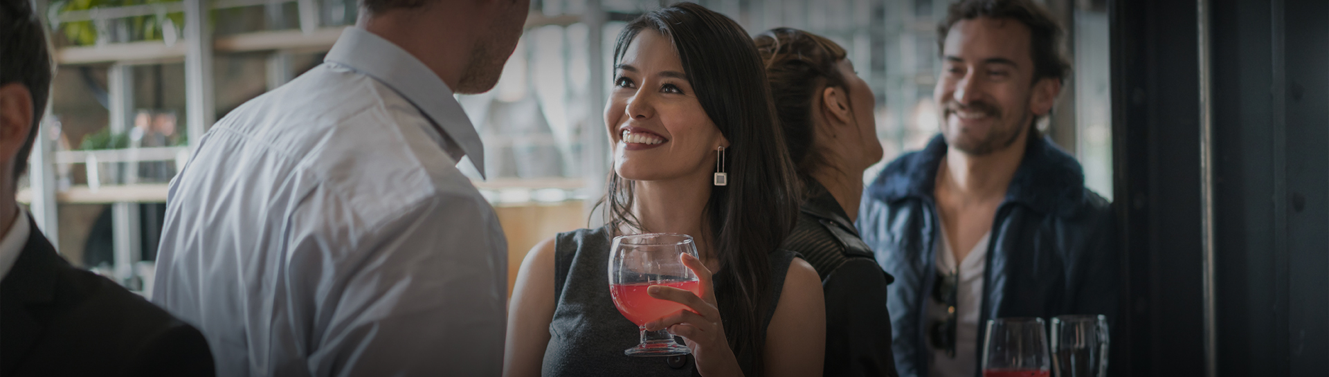 a woman holding a glass of liquid