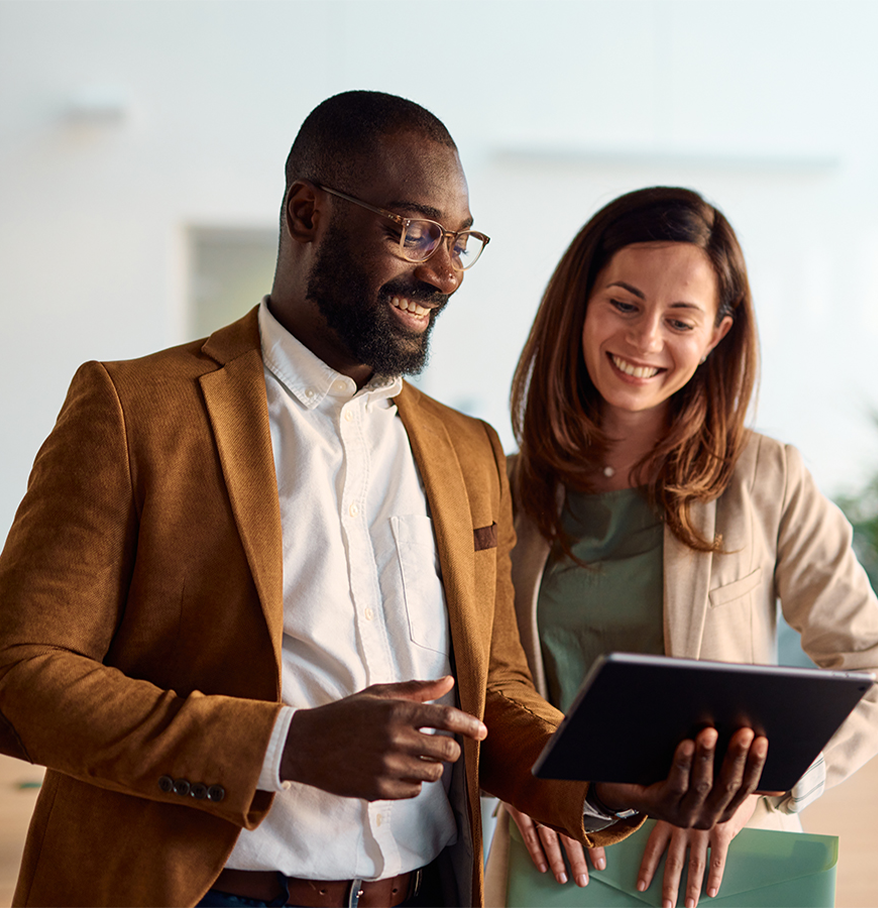 a man and woman looking at a tablet