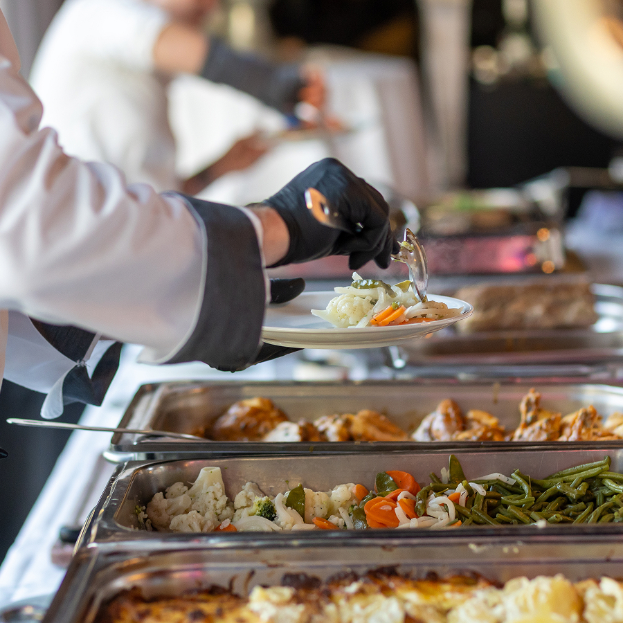 a person holding a plate of food