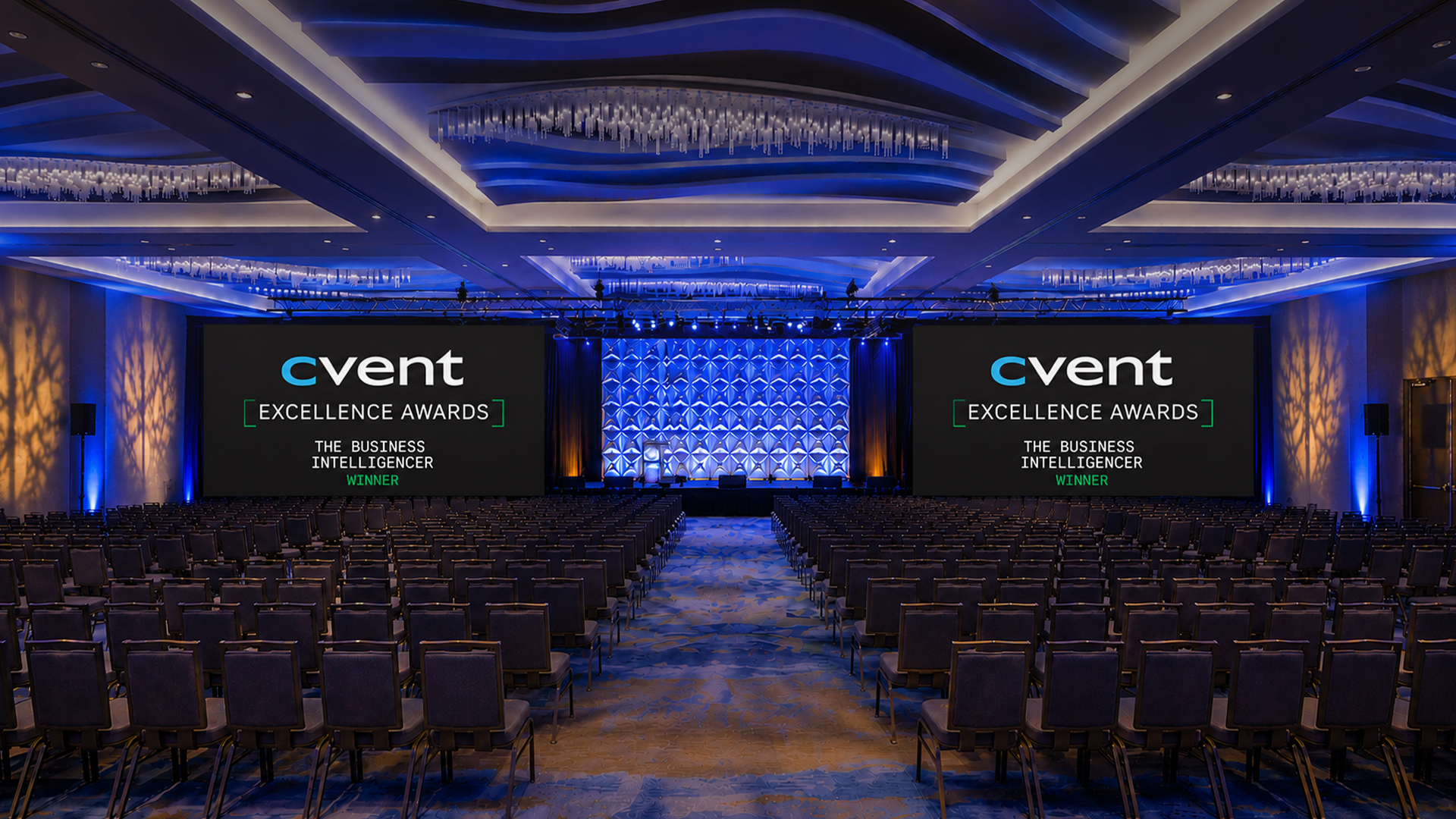 a large room with chairs and a stage with a stage and signs