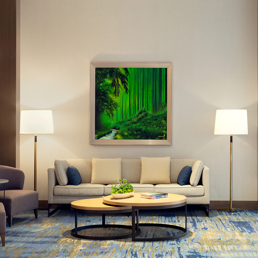 a room with a couch and a painting on the wall