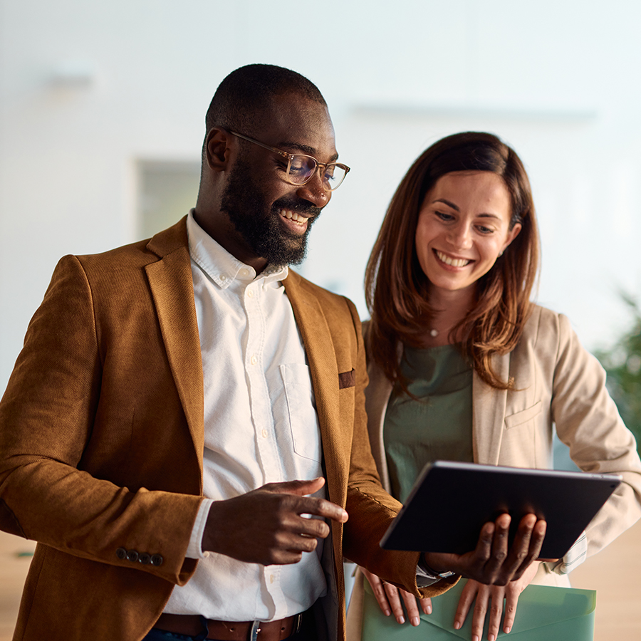 a man and woman looking at a tablet