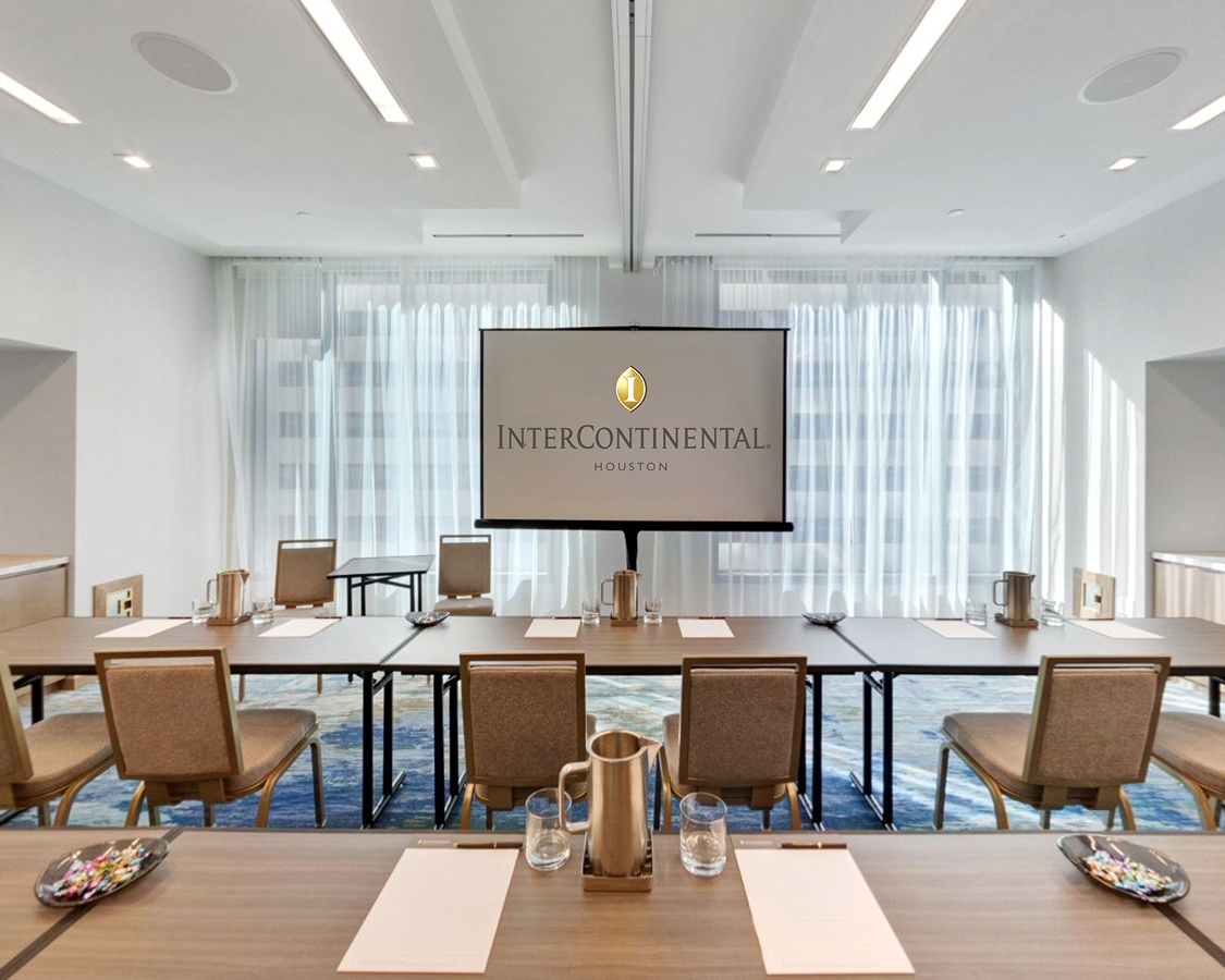 a room with a large screen and chairs