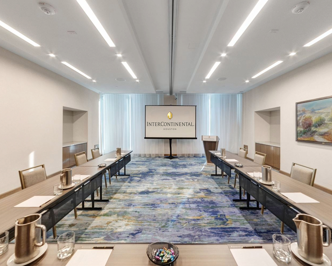 a room with long tables and chairs