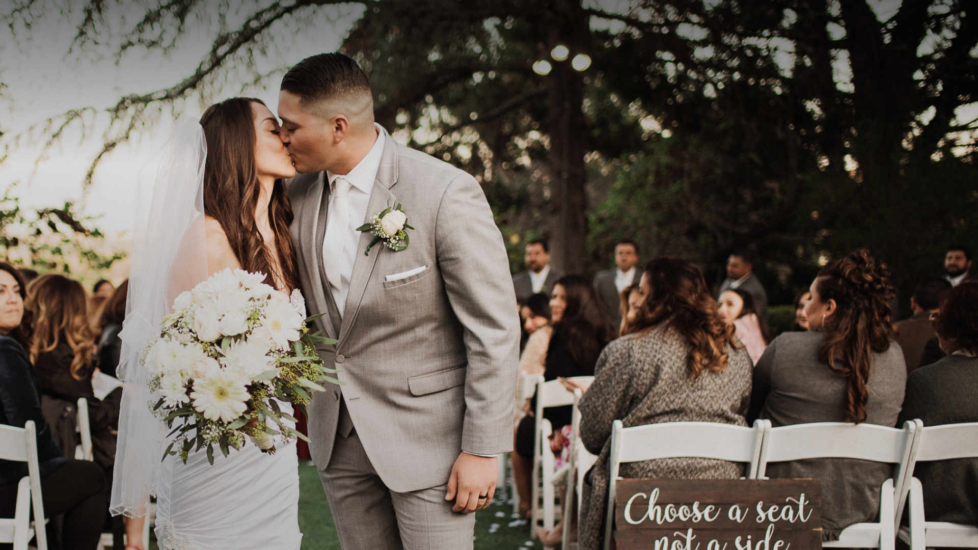 a man and woman kissing outside