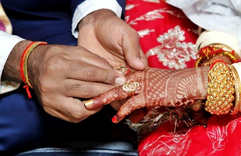 a man putting a ring on a woman's hand