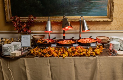 food on a table with a tablecloth and a painting