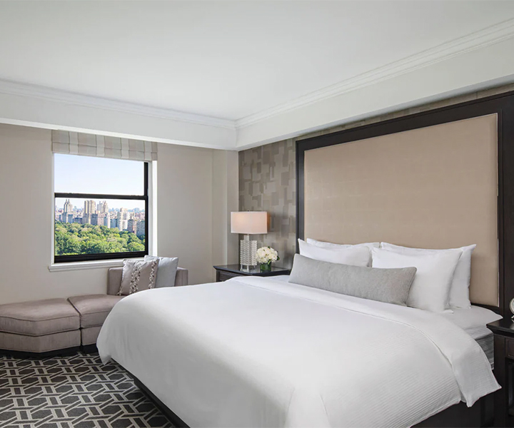 a bedroom with a large bed and a window