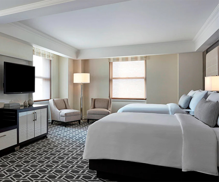 a room with two beds and a television