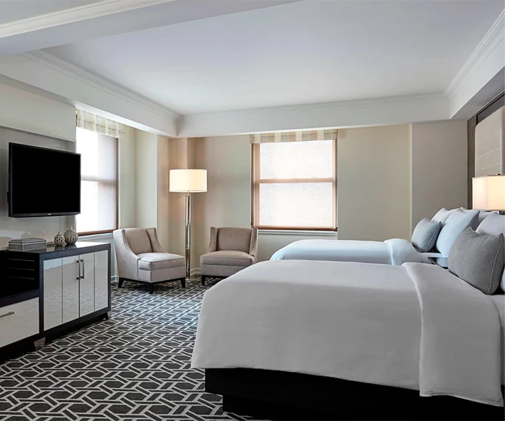 a room with two beds and a television