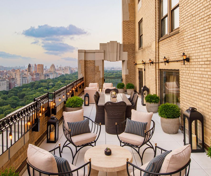 a patio with chairs and tables on a balcony