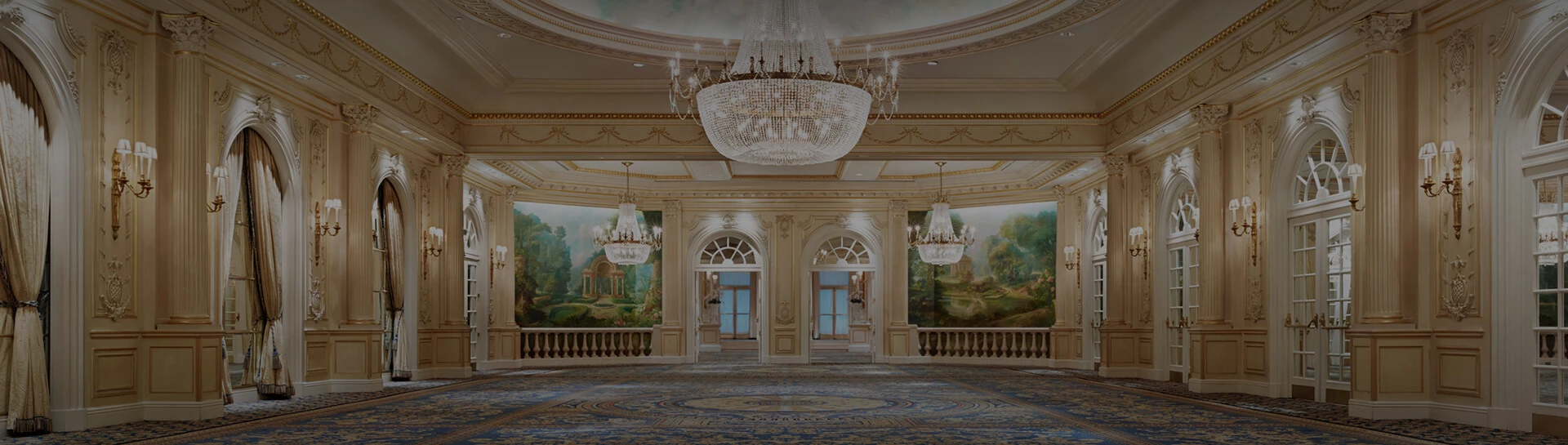 a large room with a chandelier and a wall painting