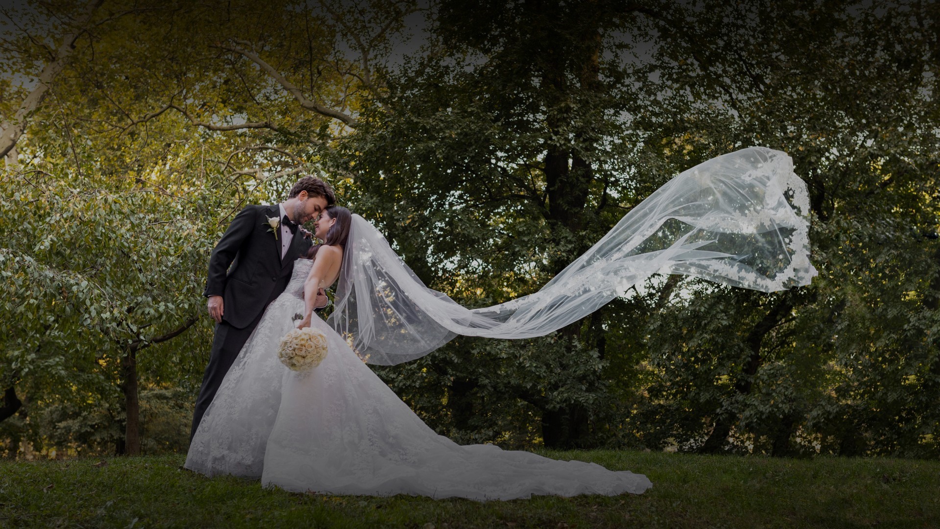 a man and woman kissing in a park