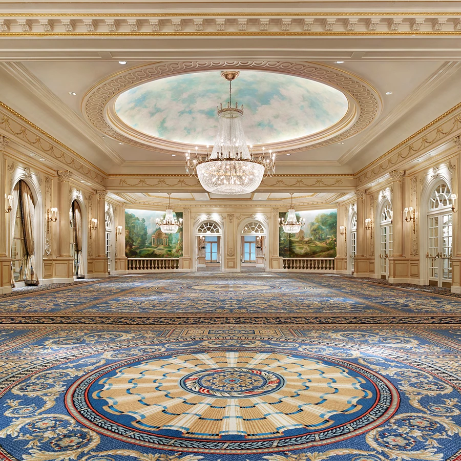 a large room with a chandelier and a blue carpet