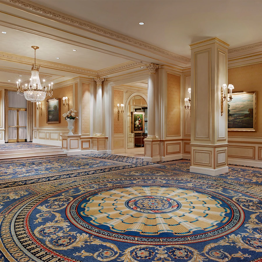 a large luxury room with a blue carpet and chandeliers