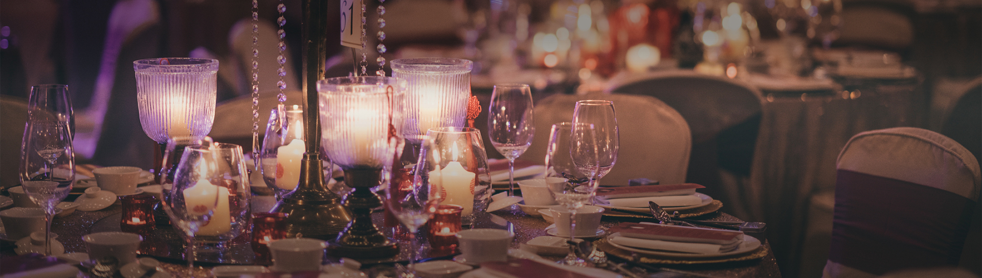 a table with wine glasses and candles