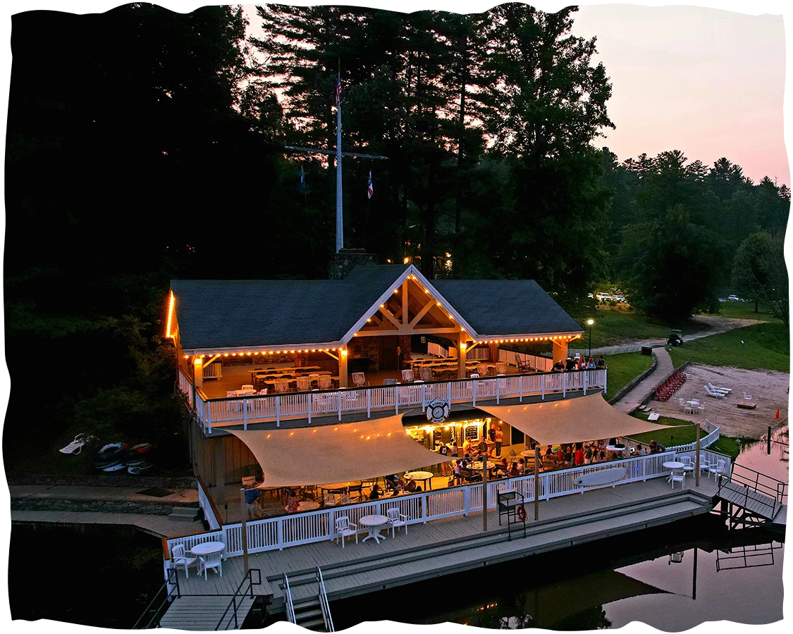 a building with a large deck and a lake