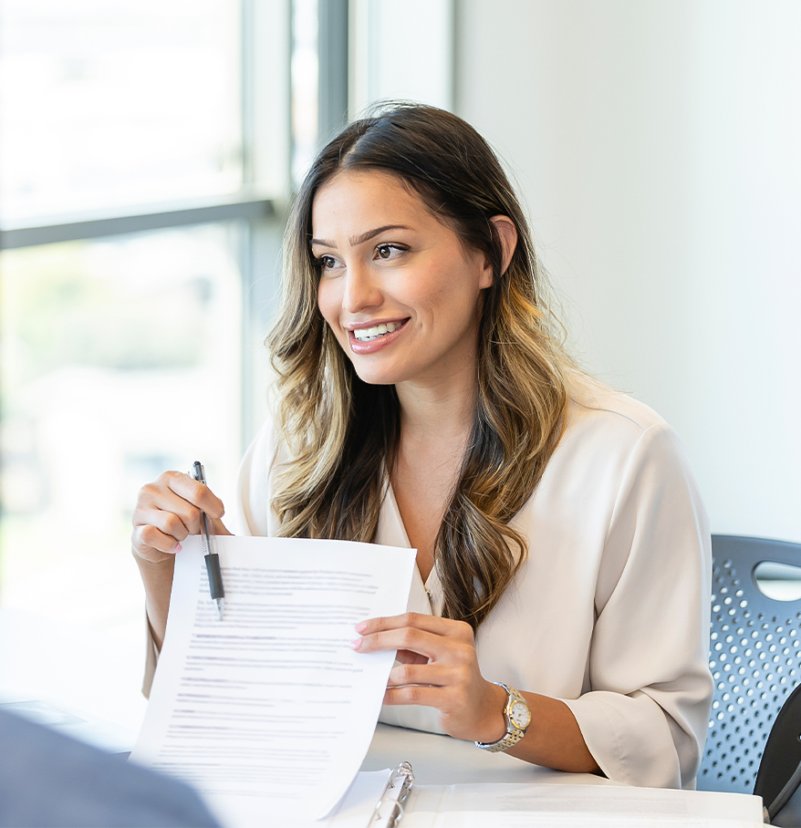 a woman holding a pen and paper