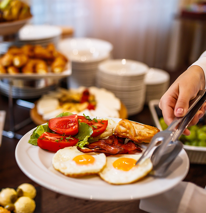a person holding a plate of food