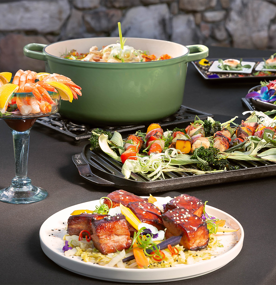 a table with plates of food and a glass of wine