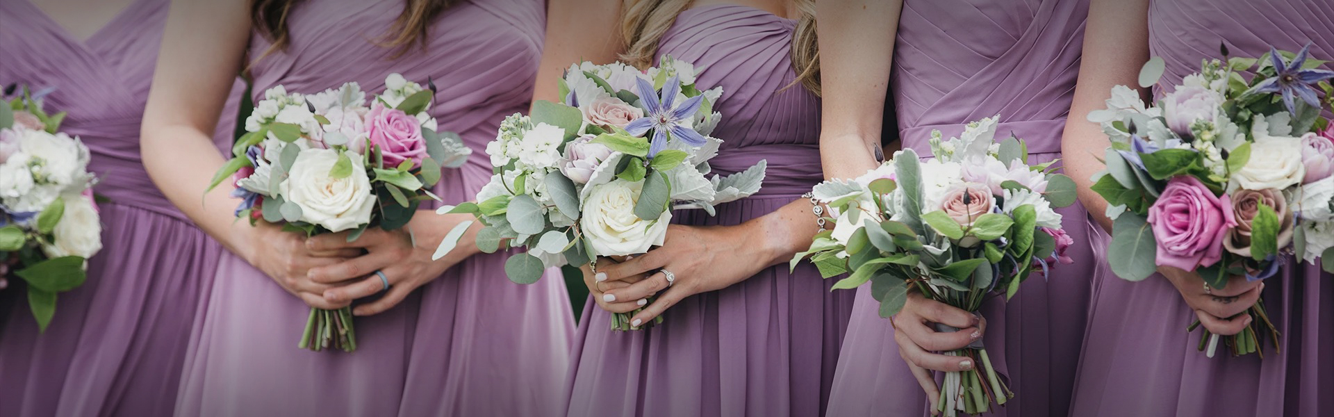 a woman in purple dresses holding flowers