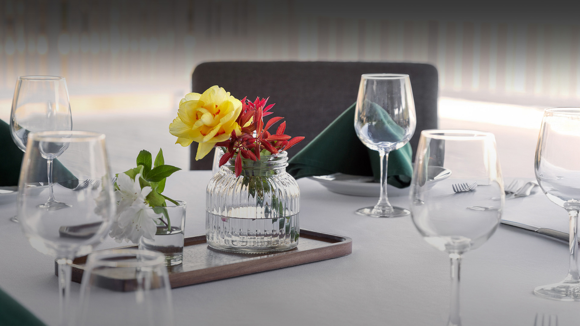 a table with glasses and flowers