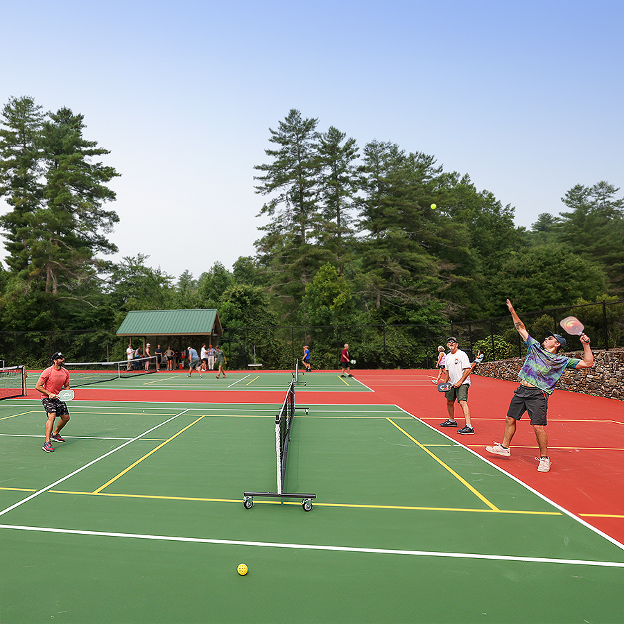 a group of people playing tennis