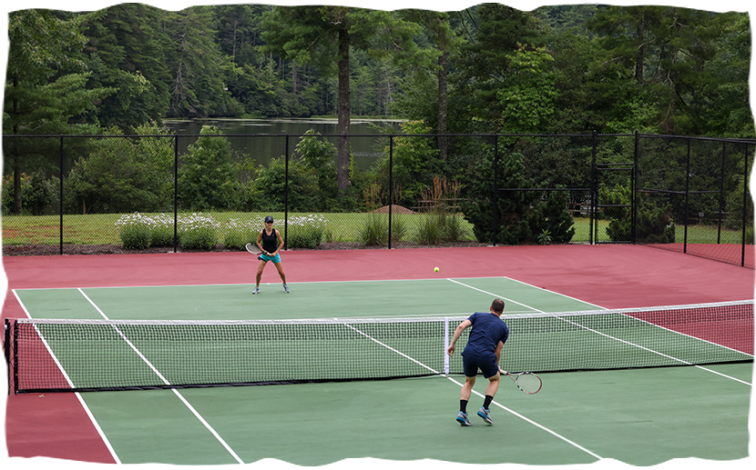 a couple of people playing tennis