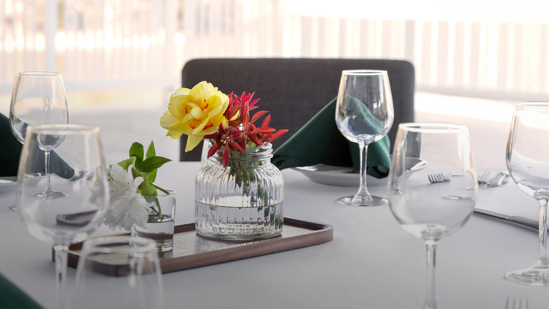 a table with glasses and flowers