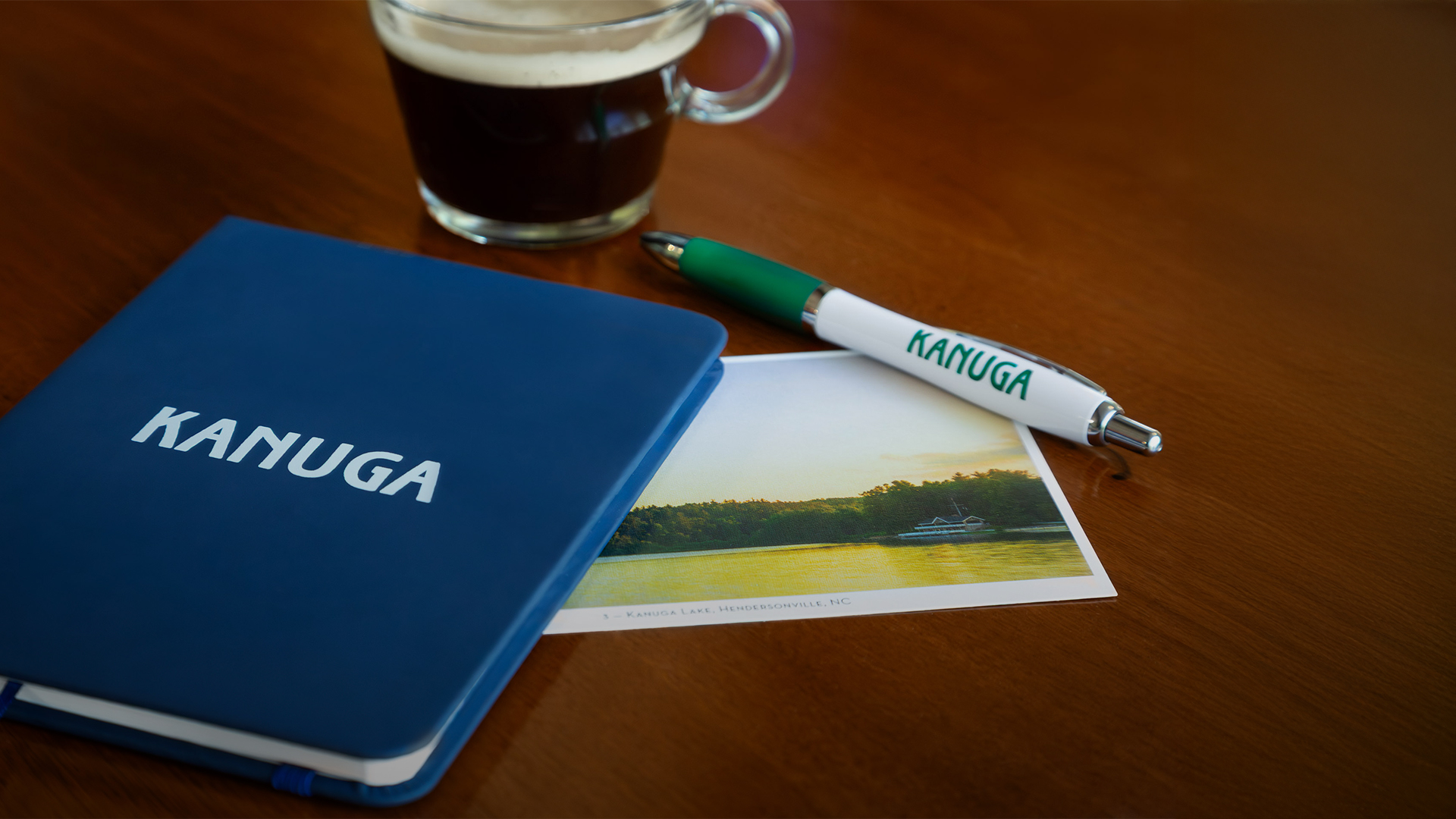 a pen and a photo of a picture and a coffee