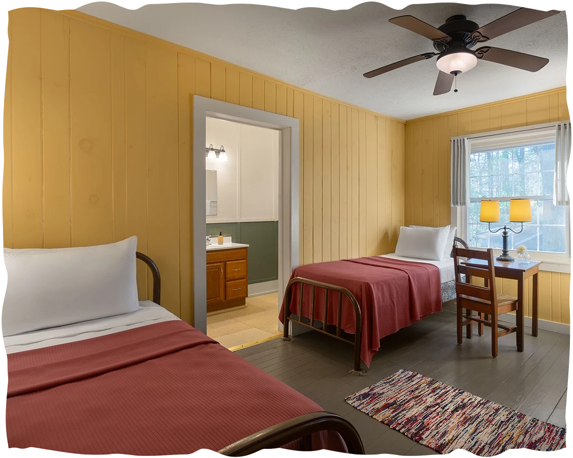 a room with two beds and a table