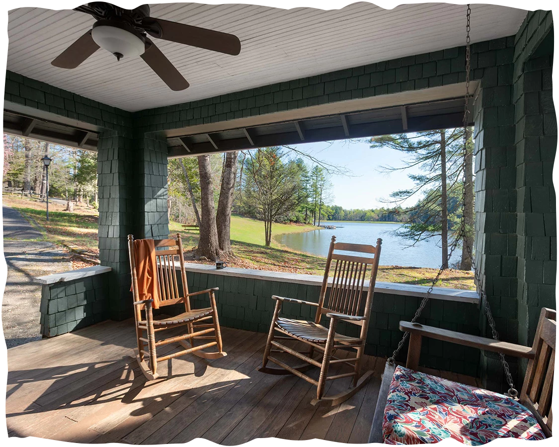 a porch with rocking chairs and a fan