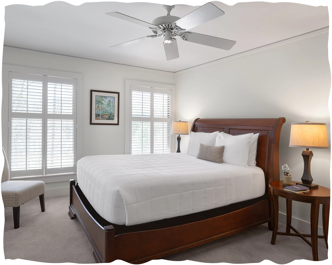 a bedroom with a bed and a fan
