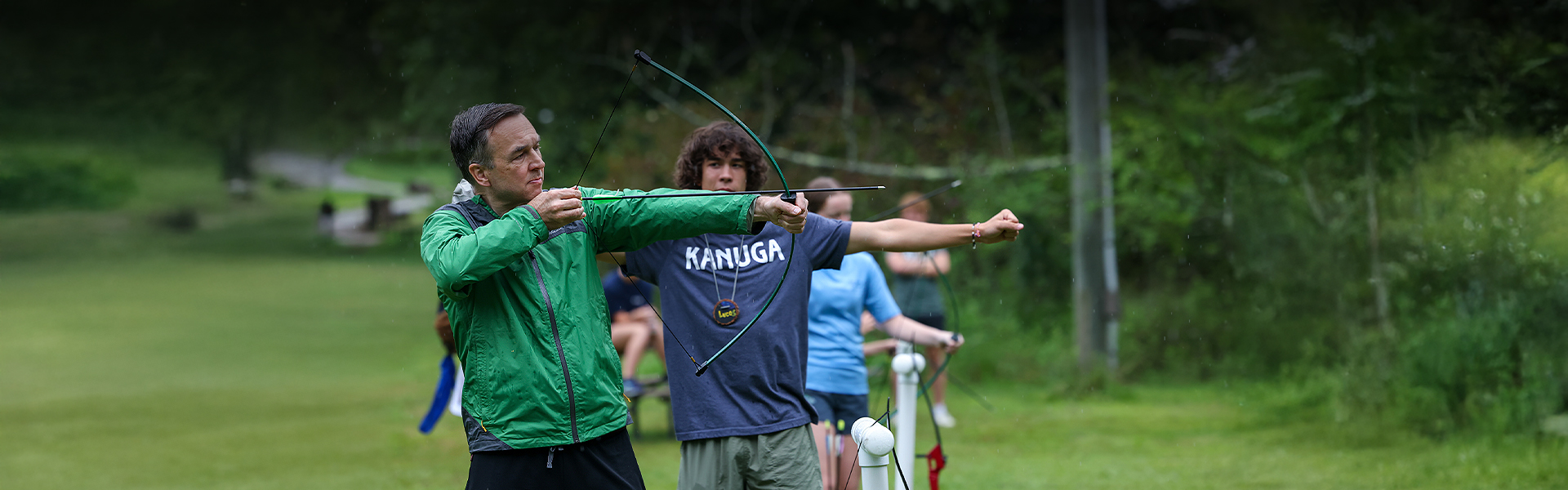 a group of people shooting bows
