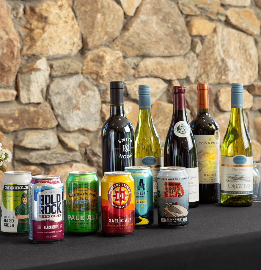 a group of bottles and cans of beer on a table