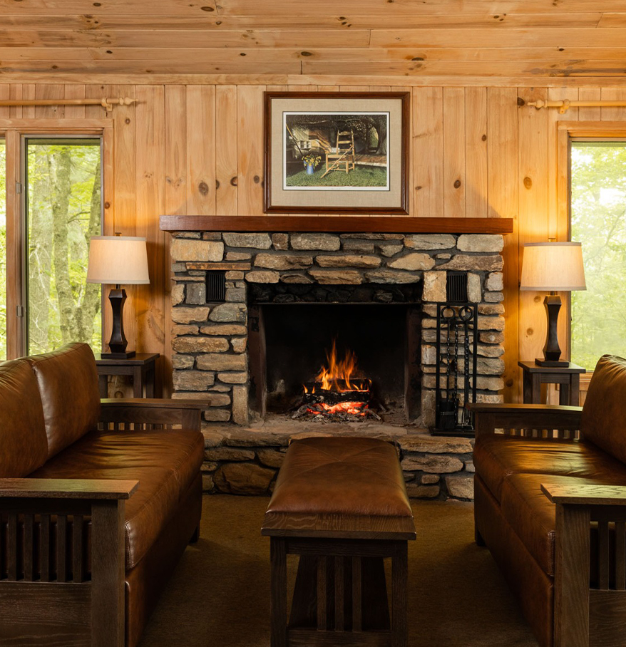 a fireplace in a room with leather furniture