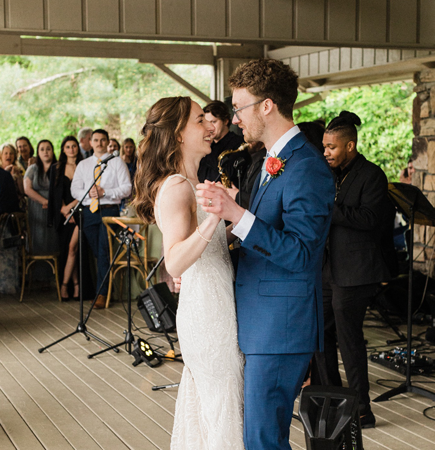 a man and woman dancing on a porch