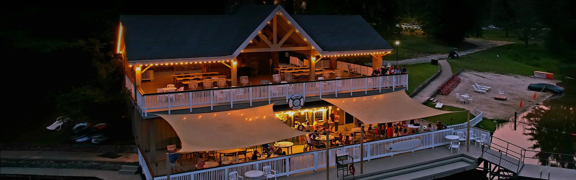 a building with tables and chairs and a white railing
