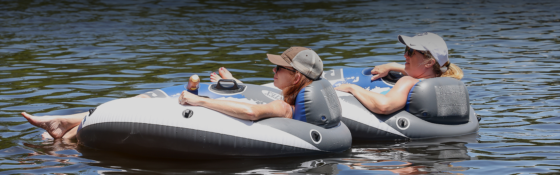 a woman in a hat and sunglasses on a raft