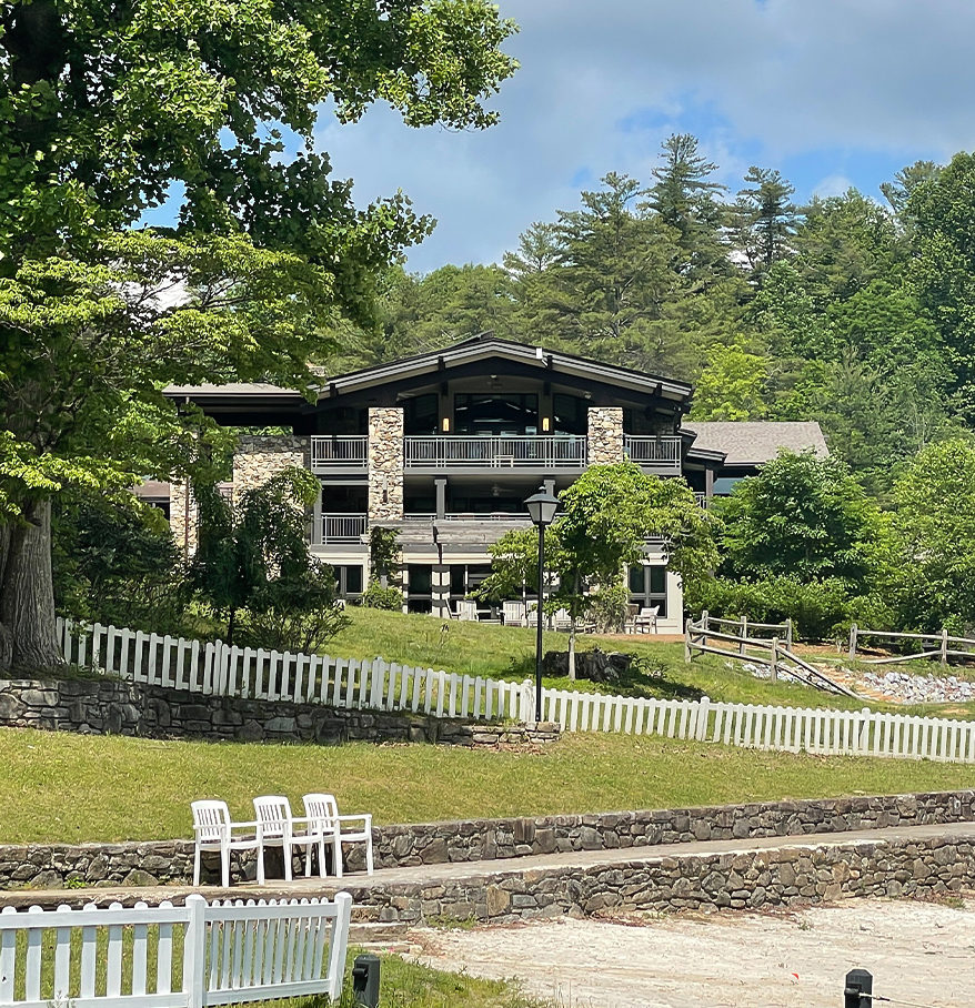 a building with a fence and trees