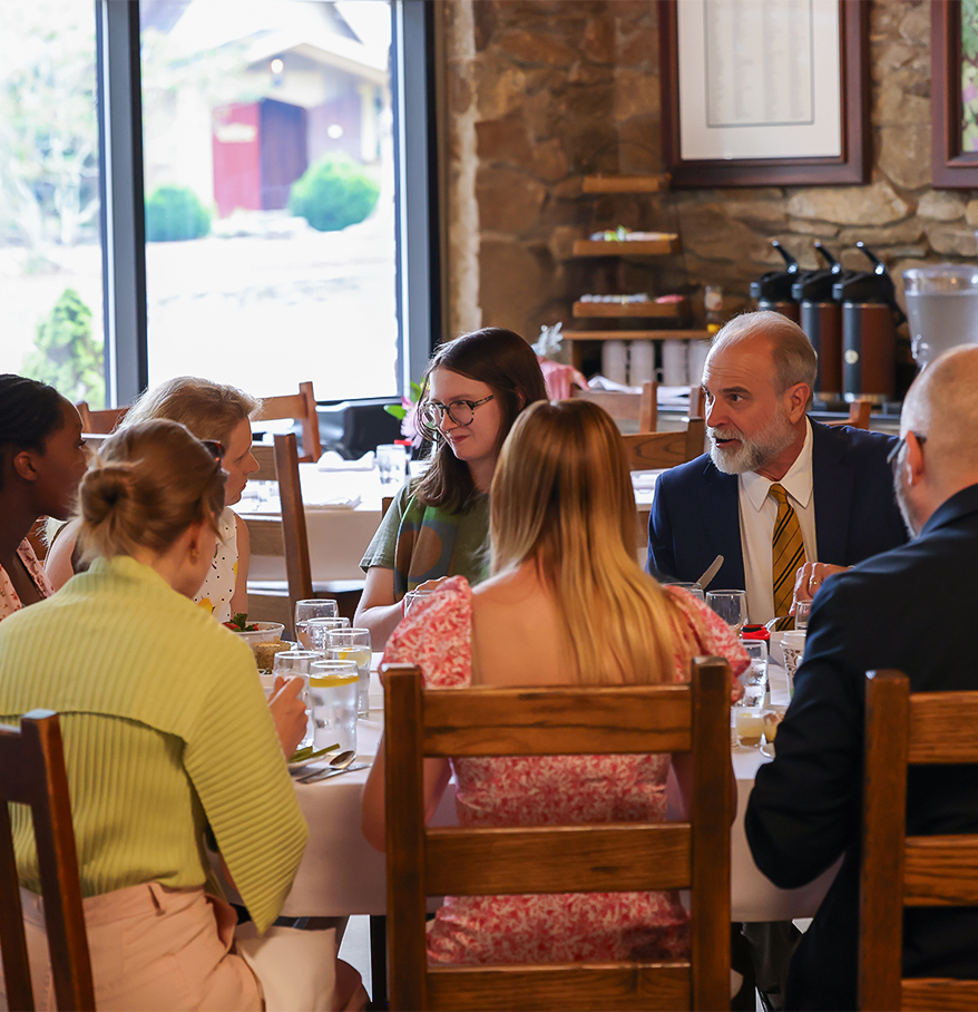 a group of people sitting around a table